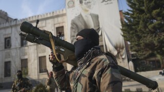 A Syrian opposition fighter holds a rocket launcher