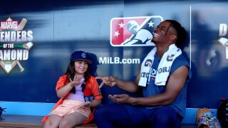 Kid Reporter plays rock, paper, scissors with Hooks' center fielder Zach Daniels