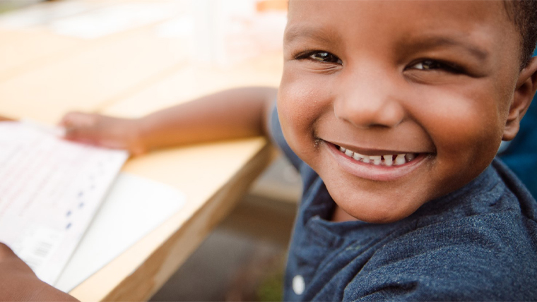 Child smiling while reading